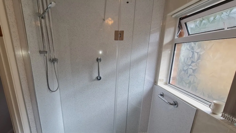 New spacious accessible shower cubicle including hand rails