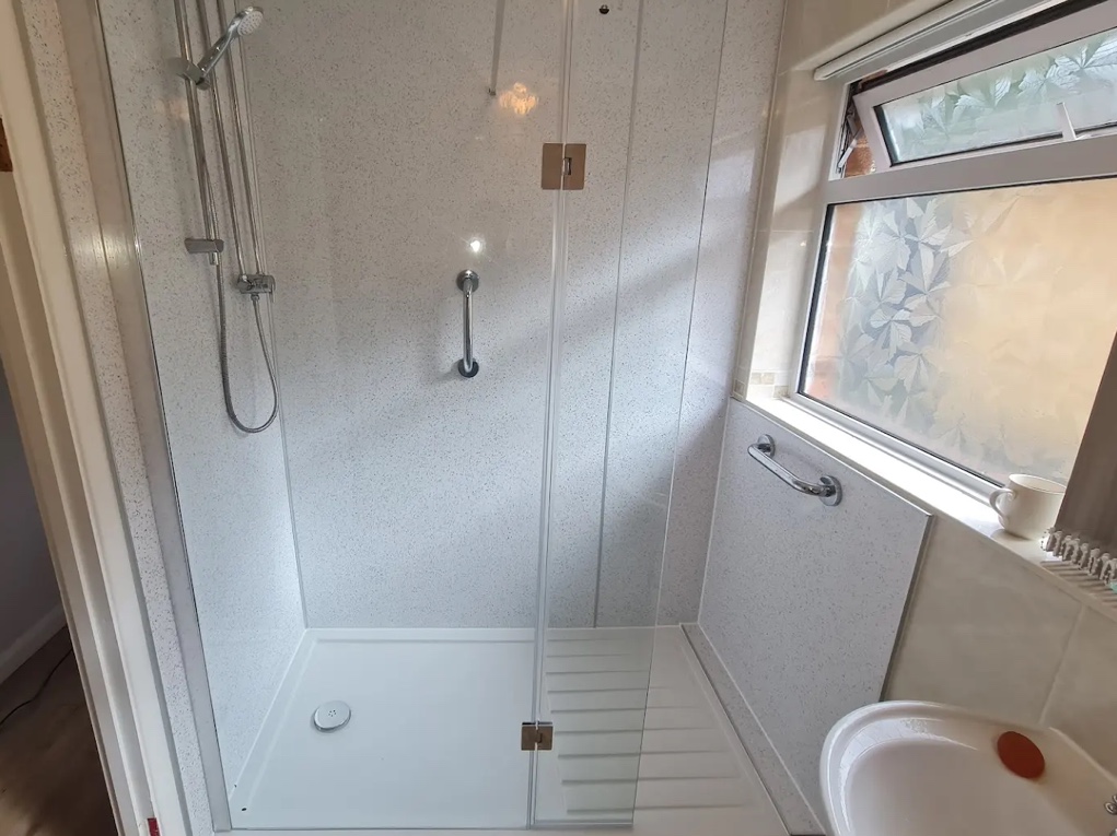 New spacious accessible shower cubicle including hand rails